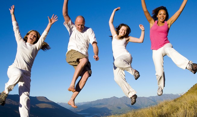Group of young people jumping in the field Concept