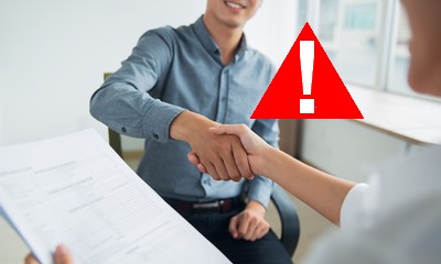 Smiling Asian businessman shaking partners hand